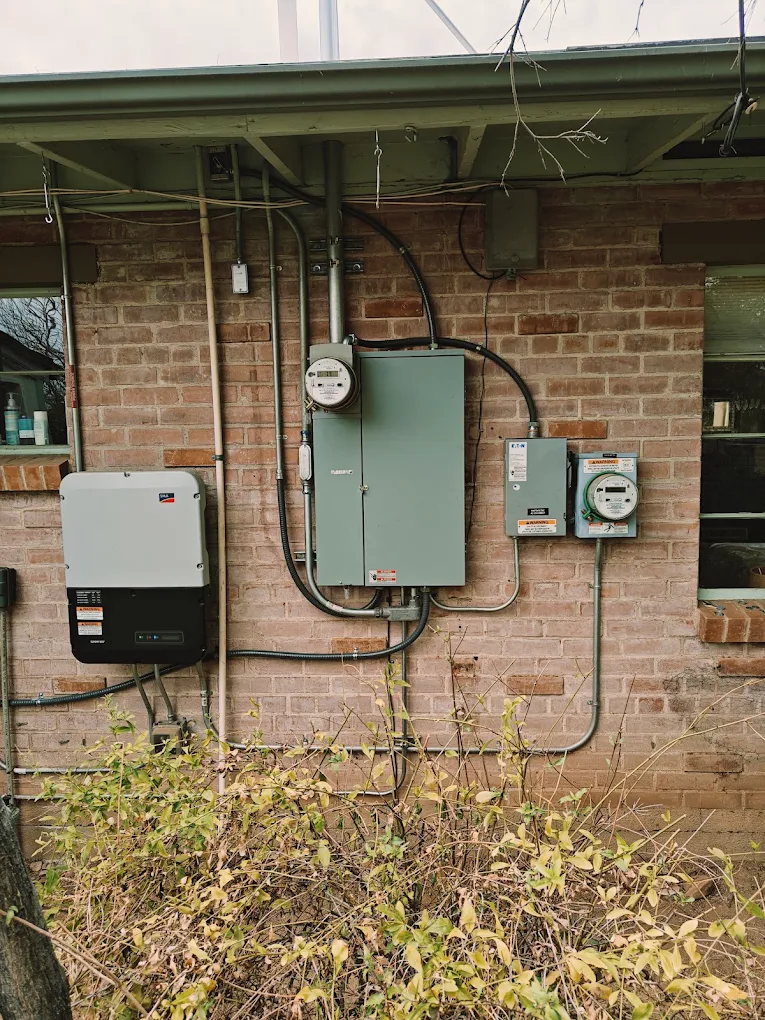 Electrical service upgrade with a new meter, main panel and disconnects on a brick home