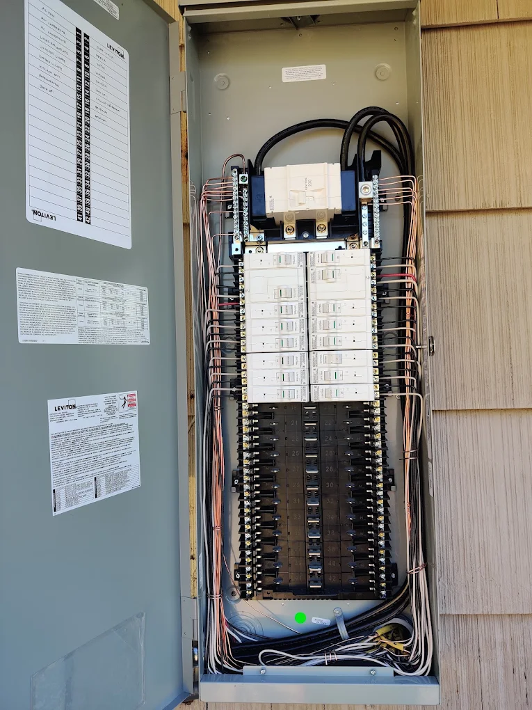 Finished breaker panel with every circuit neatly wired and a labeled panel directory