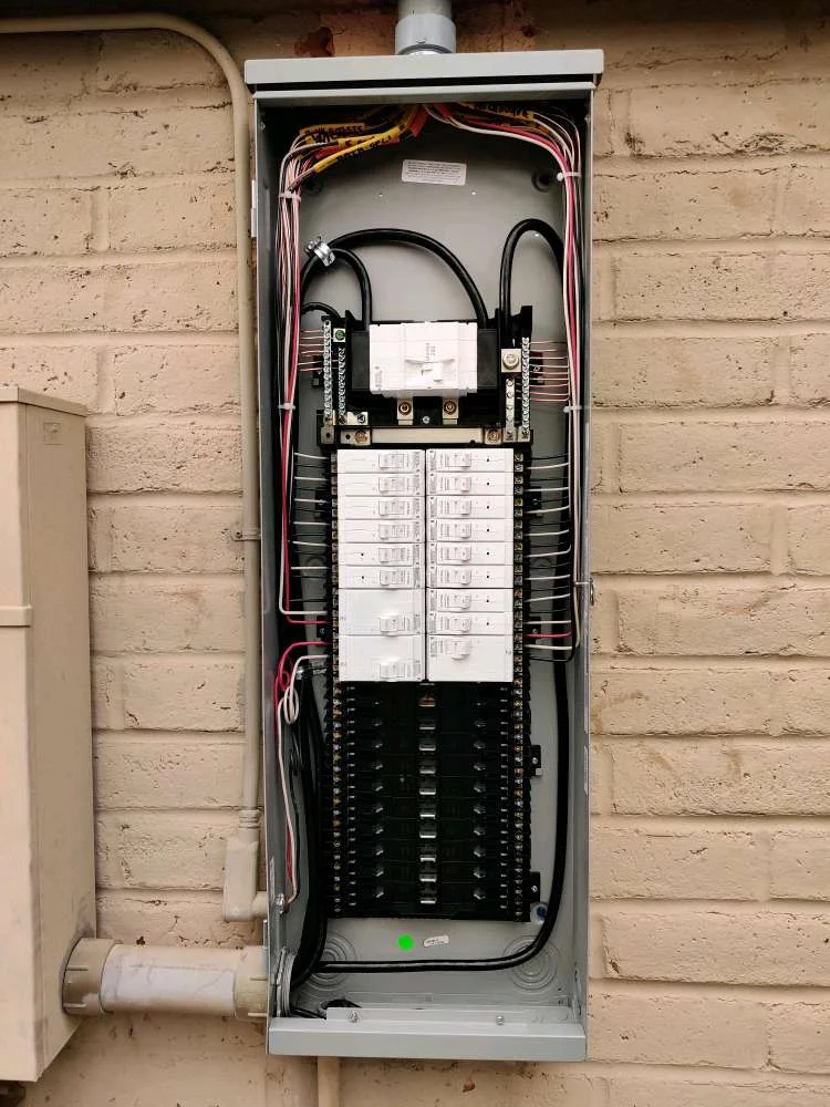 Newly installed breaker panel with neatly routed wiring on a block-wall Tucson home
