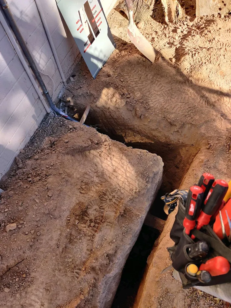 Trench and tools for an underground electrical conduit run